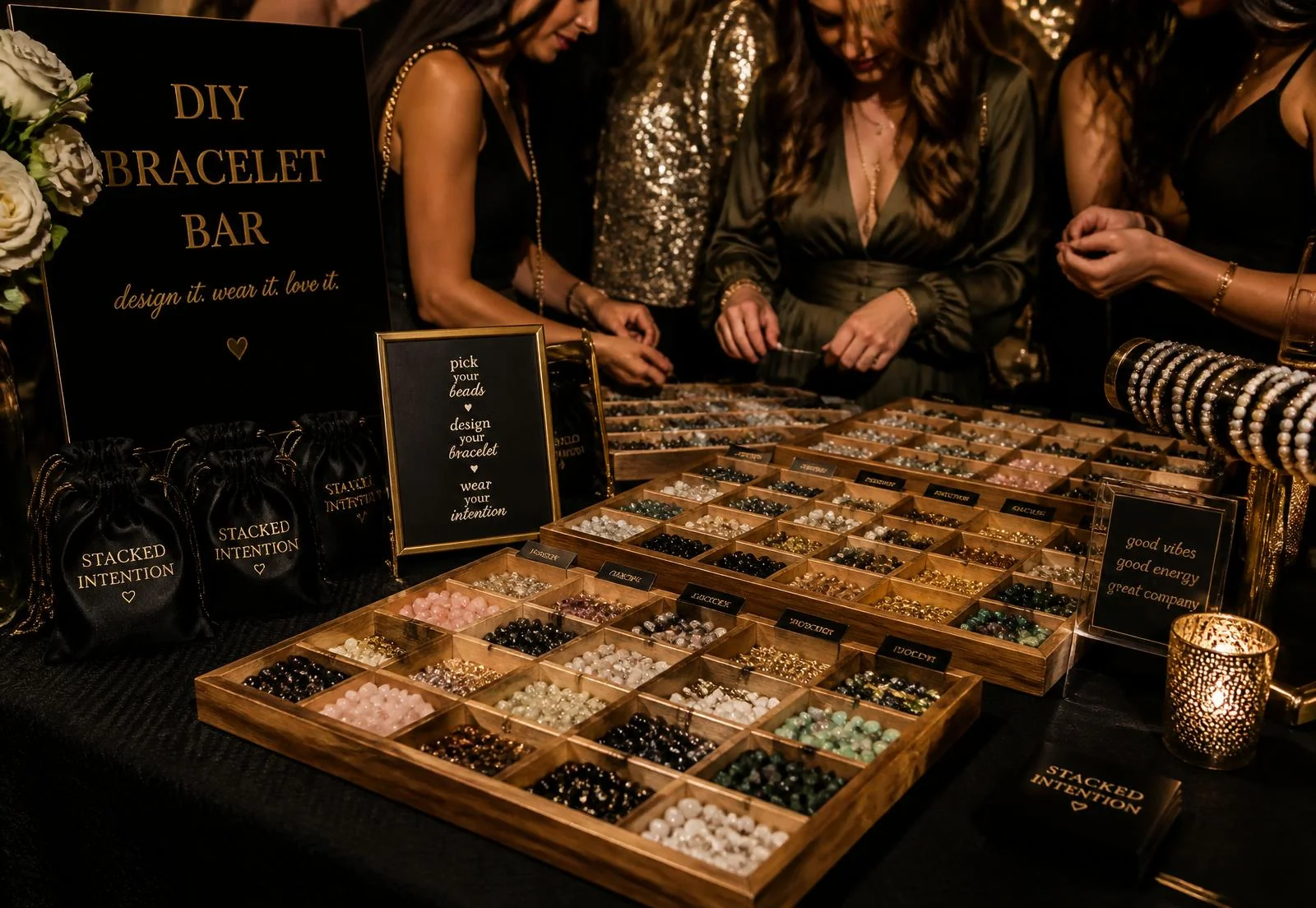 Pop-up mobile bracelet bar with wooden bead trays and keepsake jewelry bags at an event